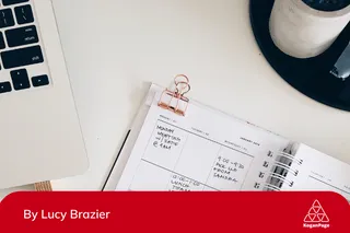 A calendar and laptop on a  table with meetings and dates