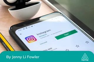 Instagram app download on a phone, next to a pencil.