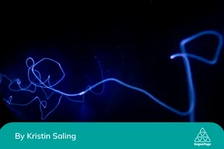 A black background with a blue light in the middle in the dark