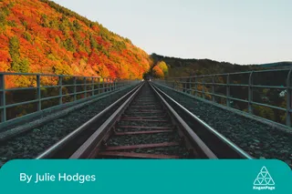 Red railway with changing seasons behind