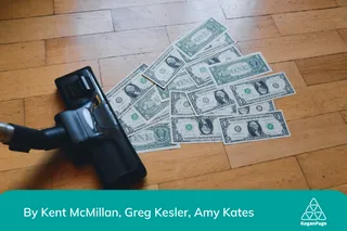 A pile of money on a wooden floor is about to be vacuumed