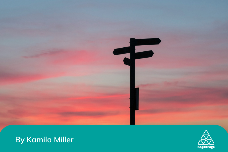 Signpost in silhouette with posts indicating different directions