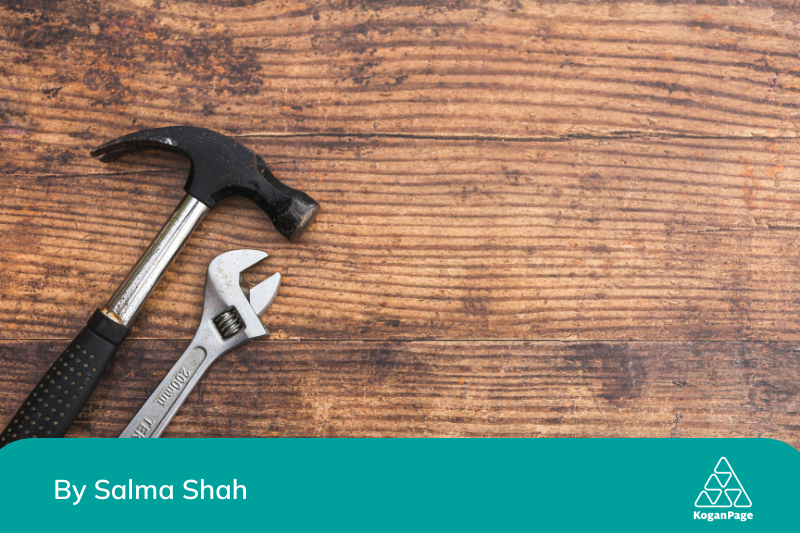 Wrench and hammer on a wooden surface, to represent fixing mistakes