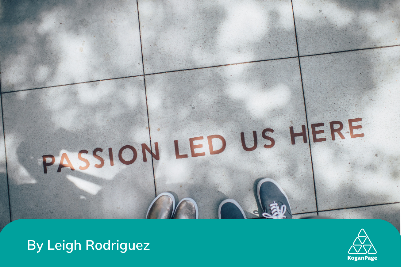 The POV of two people looking down on tile pavement with the words ‘passion led us here’ written in red on the ground