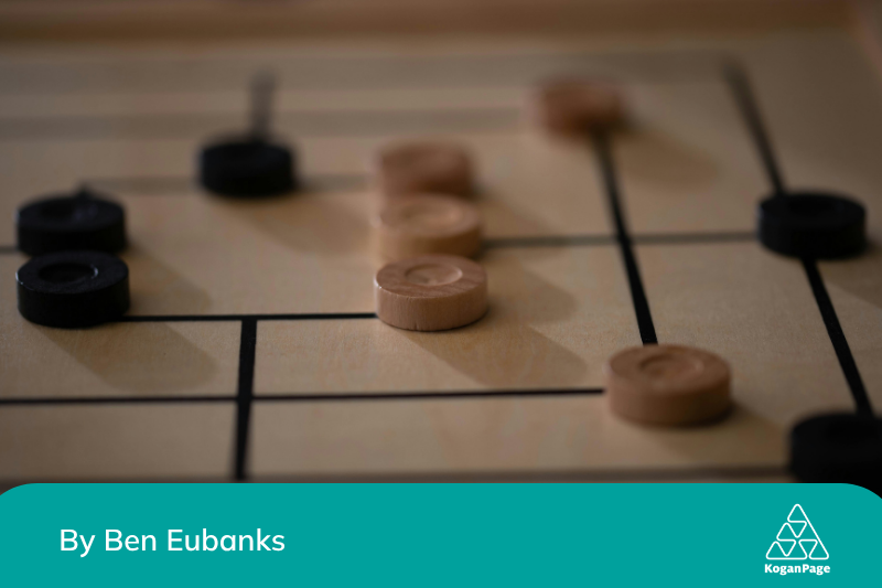 An in-game scene with light and dark wooden pieces strategically placed on a board, captured with a shallow depth of field.